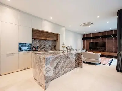 Luxurious open-plan living room with modern kitchen and elegant marble island