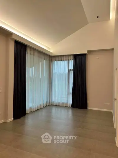 Spacious modern living room with high ceilings and large windows