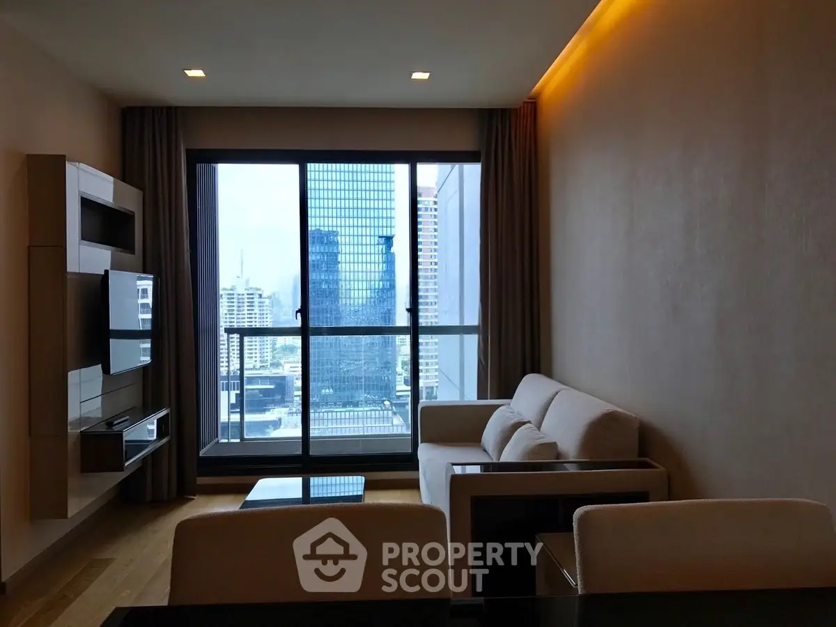 Modern living room with city view, featuring sleek furniture and large windows for natural light.