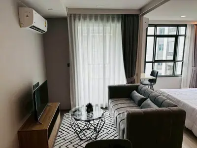 Modern living room with stylish furniture and large windows in a contemporary apartment.