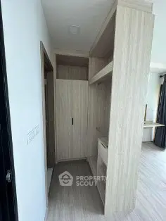 Modern walk-in closet with sleek wooden shelving and ample storage space.