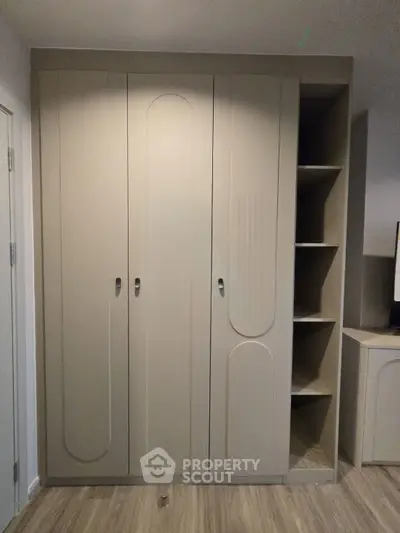 Modern built-in wardrobe with sleek design and ample storage space in a stylish bedroom.
