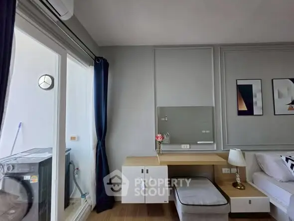 Modern living room with stylish decor and natural light from large windows.