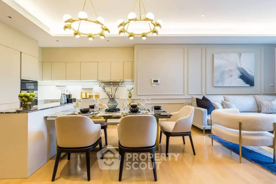 Luxurious open-plan living room and kitchen with elegant dining area and modern decor.