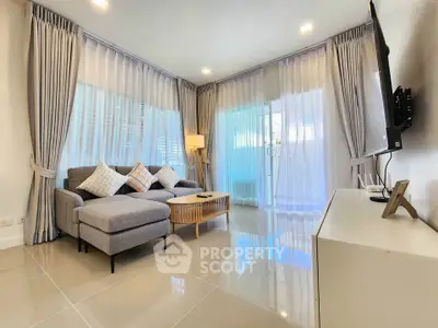 Modern living room with elegant decor and large windows