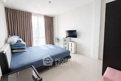 Spacious bedroom with modern decor and natural light