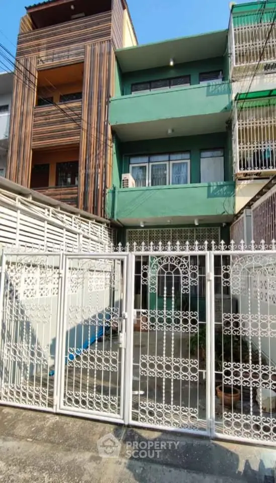 Charming multi-story building with unique facade and secure gated entrance.