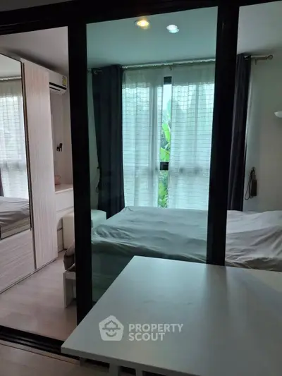 Modern compact bedroom with glass partition and natural light