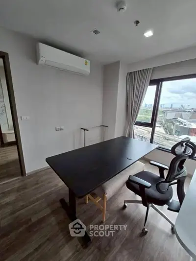 Modern study room with sleek desk and ergonomic chair, featuring large window with city view.