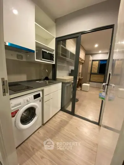 Modern compact kitchen with washing machine and sleek design