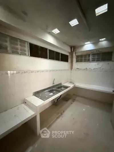 Spacious kitchen with dual sinks and ample counter space in a modern home.
