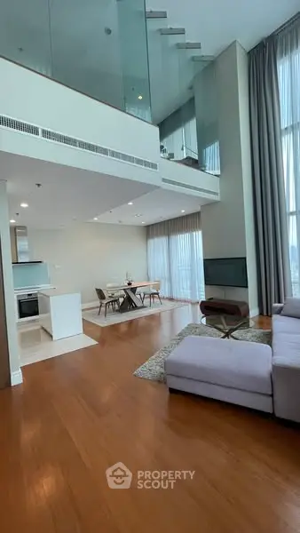 Luxurious duplex living room with high ceilings and modern decor