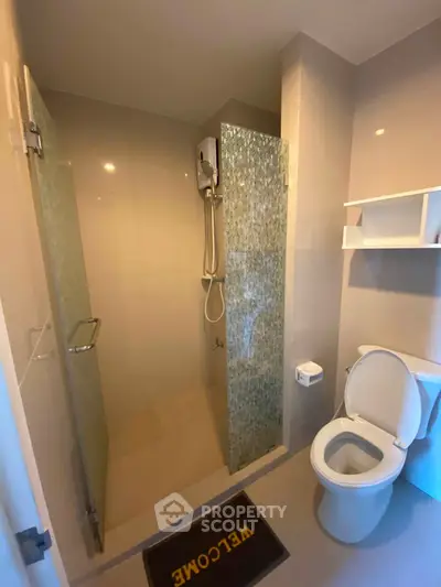 Modern bathroom with glass shower and toilet in sleek design