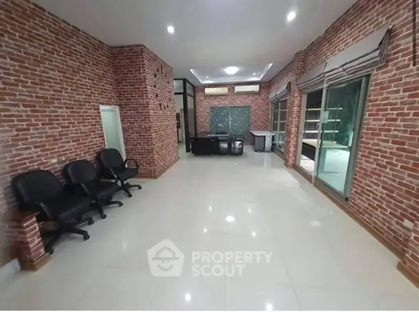 Spacious office interior with brick walls and modern furnishings