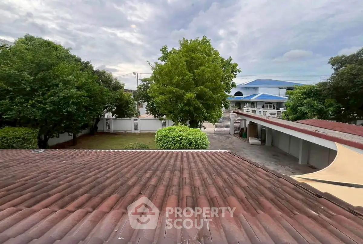 Charming suburban view with lush greenery and tiled rooftops, perfect for serene living.