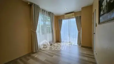 Spacious empty room with large windows and elegant curtains, perfect for customization.