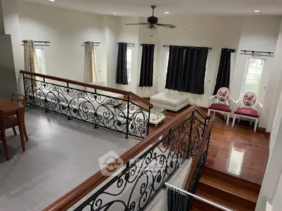 Spacious living room with elegant railing and stylish seating area