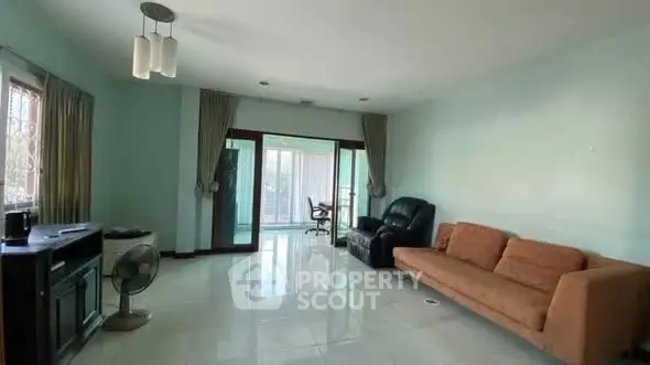 Spacious living room with modern furniture and large windows for natural light.