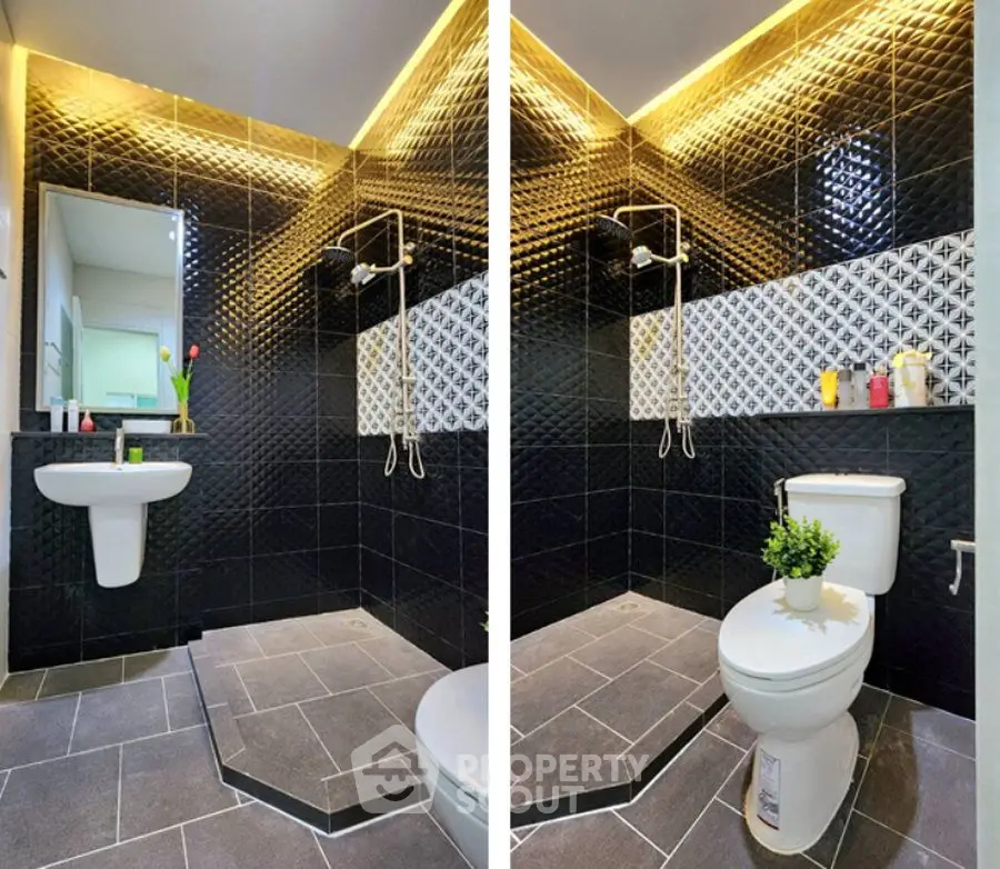 Modern bathroom with stylish black tiles and elegant lighting