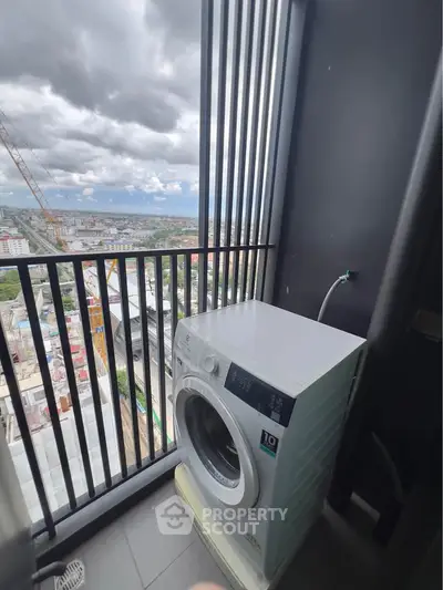 High-rise balcony with washing machine and stunning city view