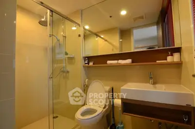 Modern bathroom with glass shower and sleek fixtures