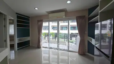 Spacious living room with balcony view in modern apartment
