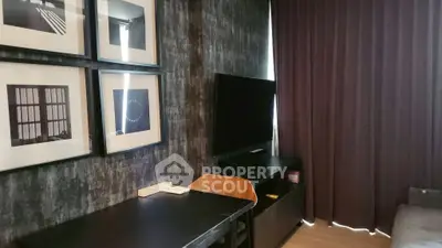 Stylish modern living room with TV, artwork, and elegant curtains.