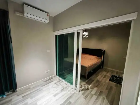 Modern bedroom with sliding glass doors and air conditioning unit