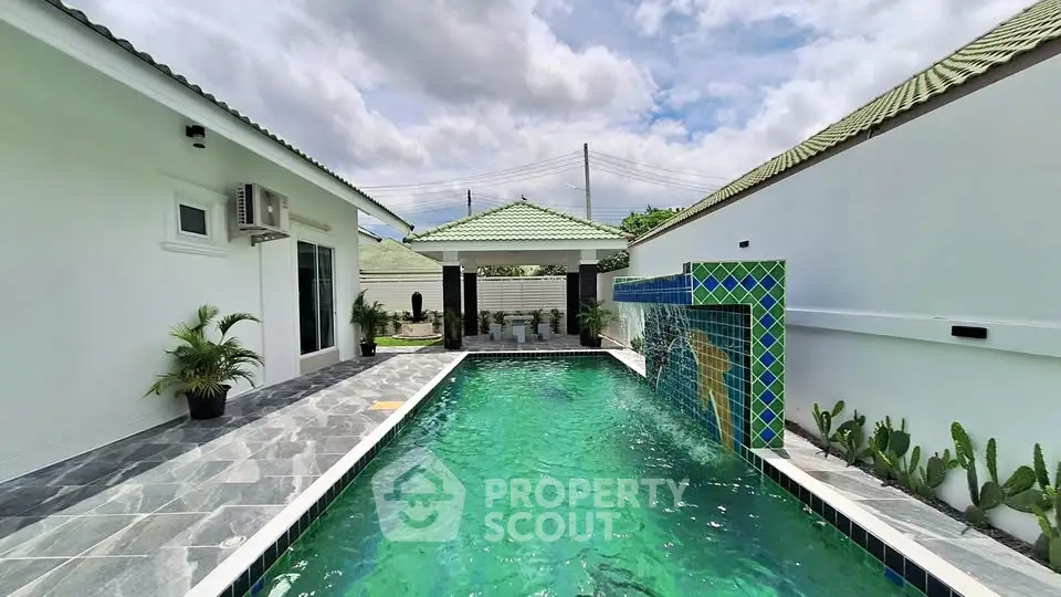 Luxurious private pool area with modern design and lush greenery, perfect for relaxation and entertainment.