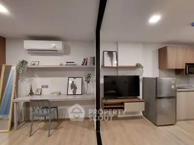 Modern studio apartment with stylish decor and open layout, featuring a sleek kitchen and cozy workspace.