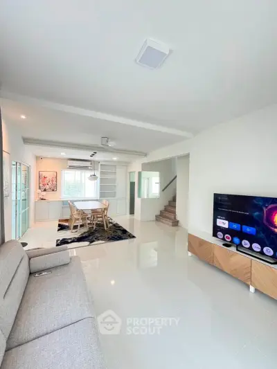 Spacious modern living room with sleek furniture and open layout, perfect for family gatherings.