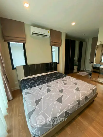 Modern bedroom with stylish decor and large windows for natural light