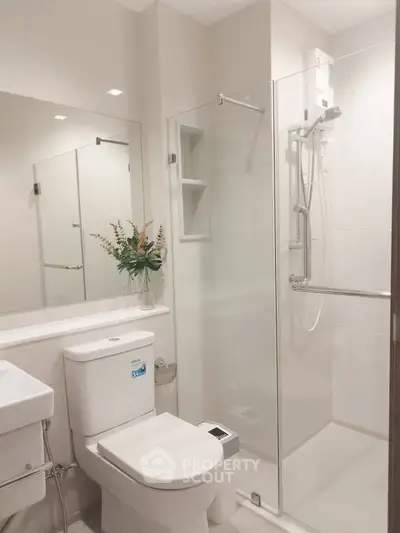 Modern bathroom with glass shower enclosure and sleek fixtures