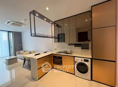 Modern open-layout kitchen with sleek cabinetry and integrated appliances in a stylish apartment.