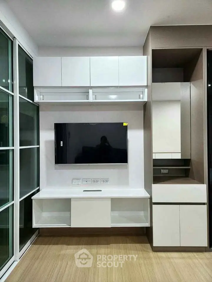 Modern living room with sleek TV unit and ample storage space