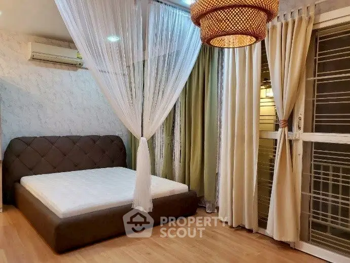 Elegant bedroom with stylish lighting and cozy curtains, perfect for relaxation.