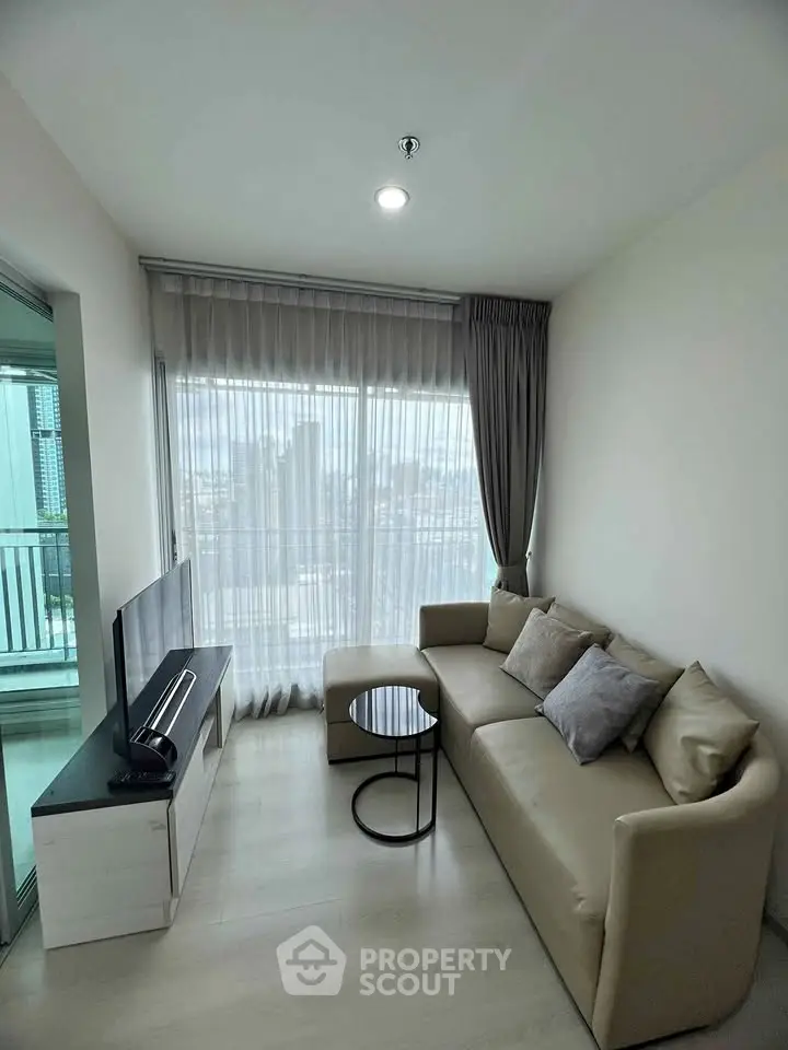 Modern living room with sleek sofa and city view from large window