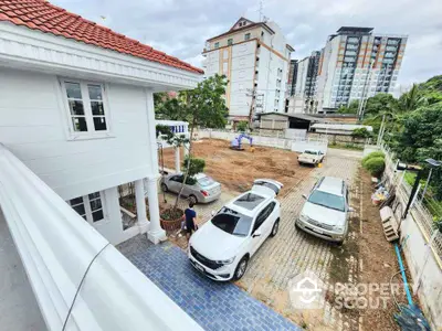 Spacious residential property with ample parking and modern architecture in urban setting.