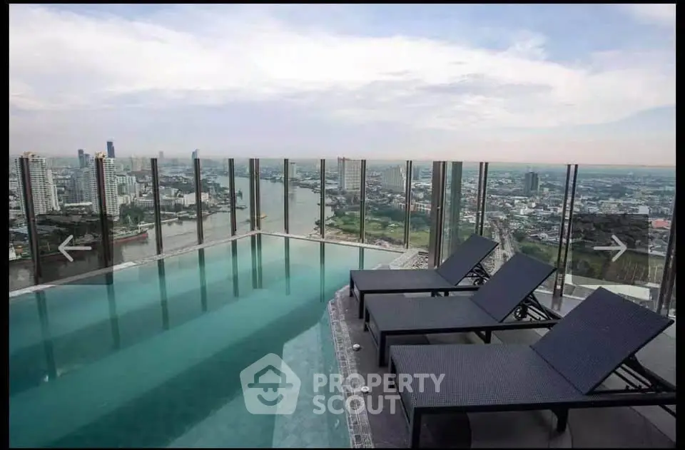Stunning rooftop pool with panoramic city views and luxurious lounge chairs.