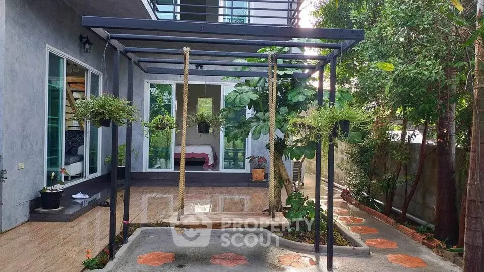 Charming garden view with modern patio and lush greenery, perfect for relaxation and outdoor enjoyment.