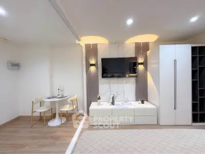 Modern studio apartment with elegant decor and cozy dining area