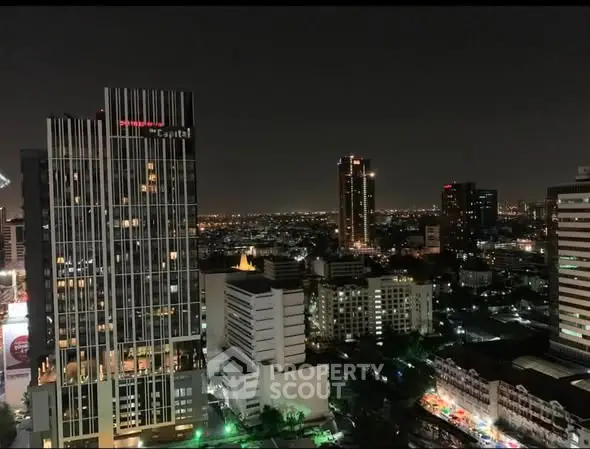 Stunning night cityscape view from high-rise building in vibrant urban area.