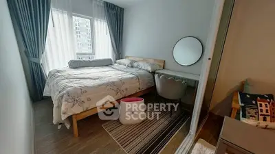 Cozy bedroom with modern decor and large window in urban apartment