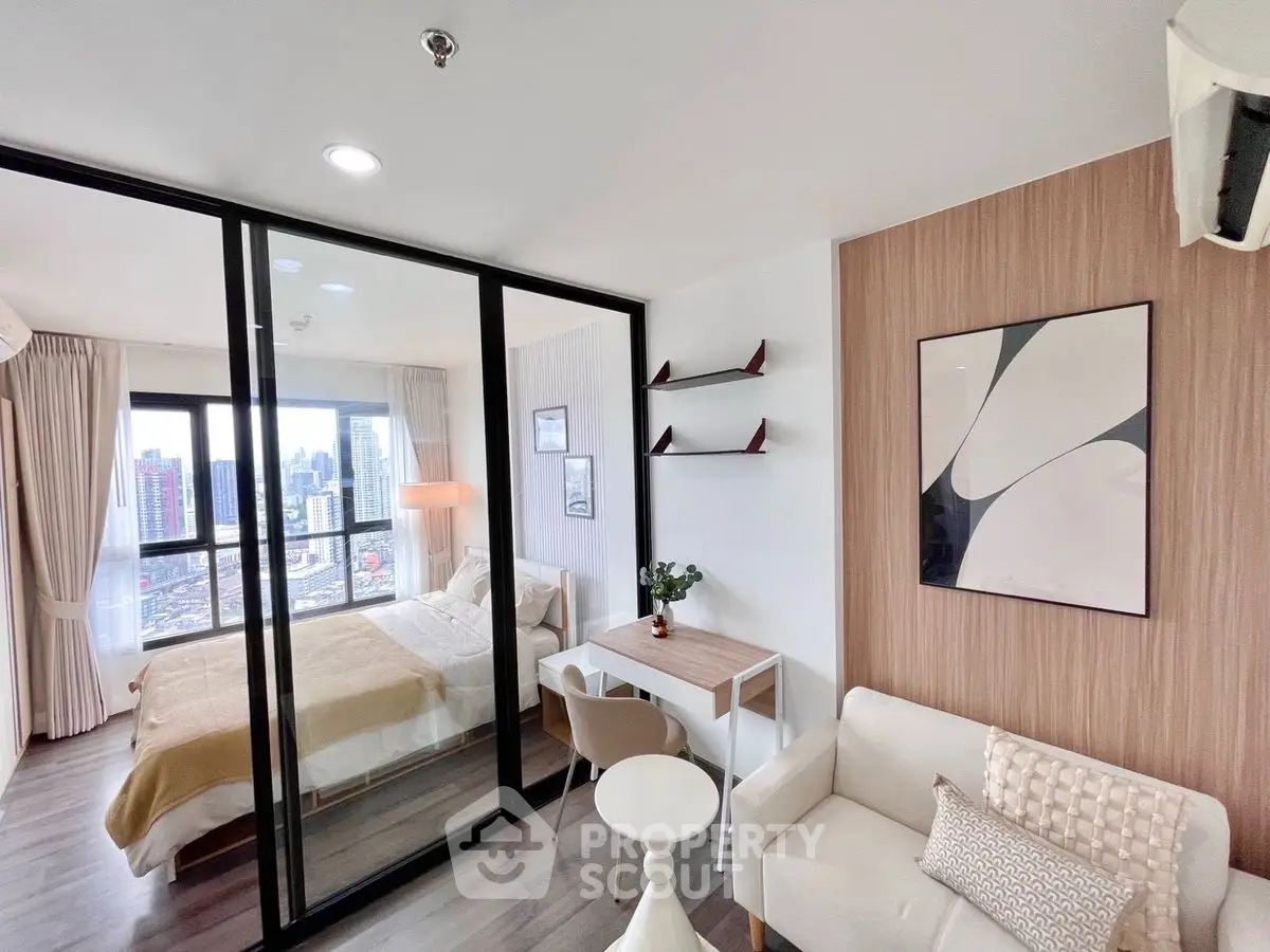 Modern studio apartment with glass partition, cozy living area, and city view.