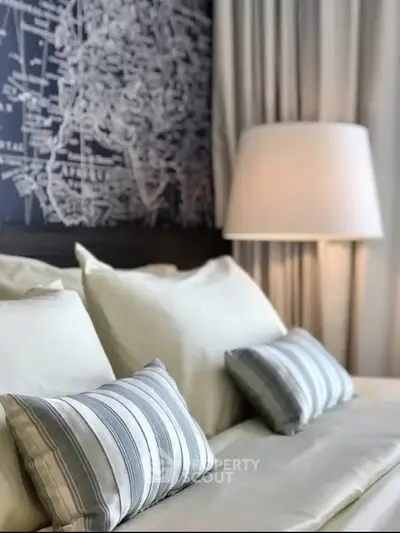 Elegant bedroom with stylish decor and cozy pillows, perfect for relaxation.