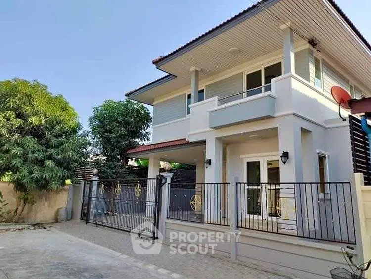 Modern two-story house with gated entrance and spacious driveway
