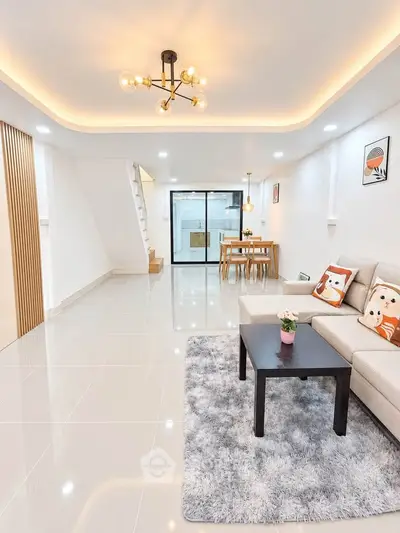 Spacious modern living room with elegant lighting and cozy decor