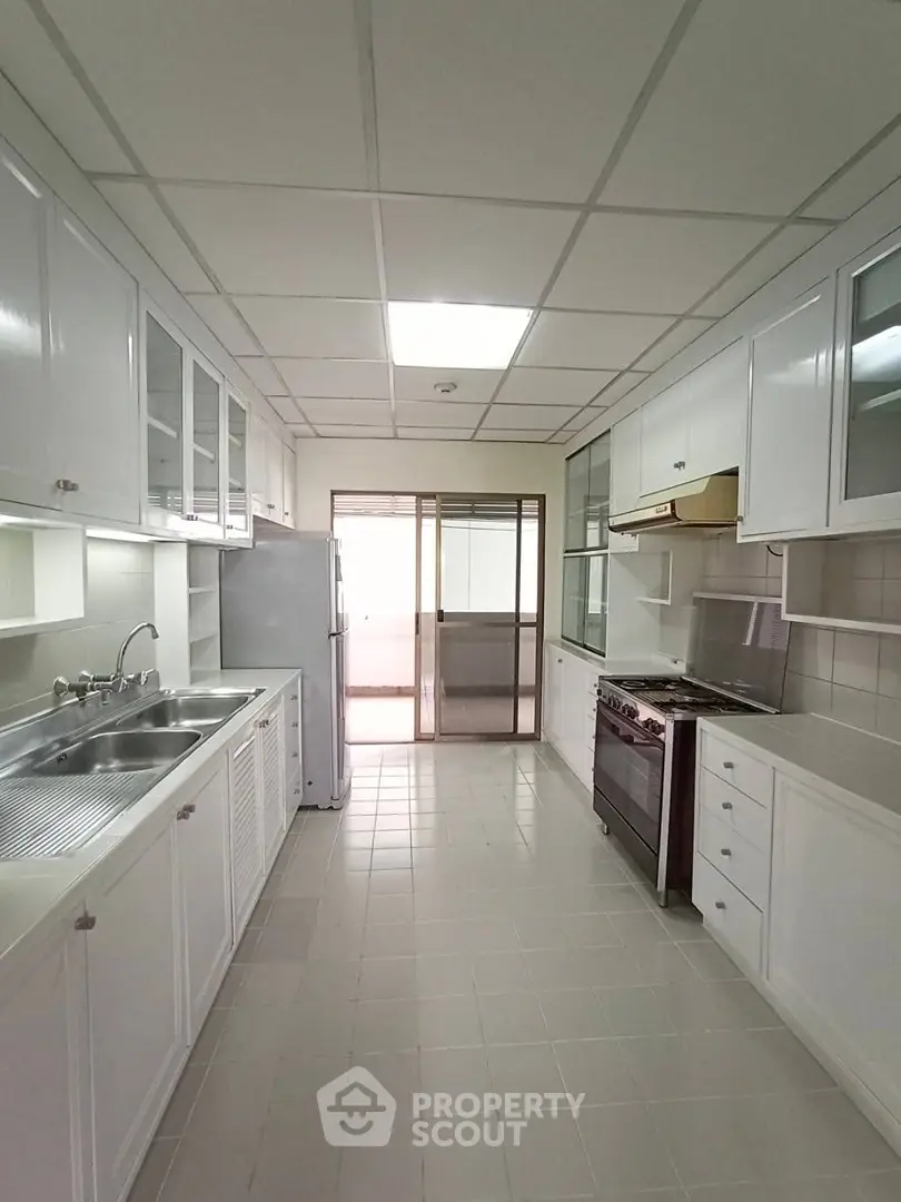 Spacious kitchen with modern appliances and ample storage in a bright, airy layout.