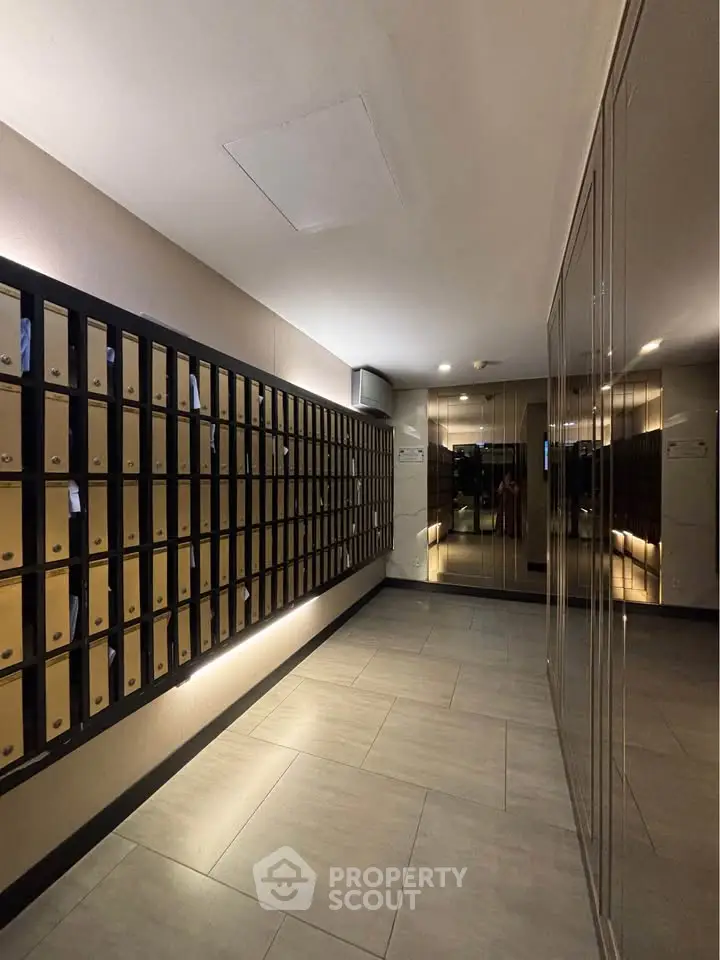 Modern apartment building lobby with mailboxes and sleek design.