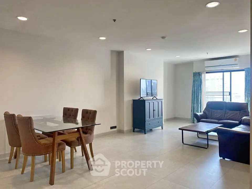 Spacious modern living room with dining area and large windows